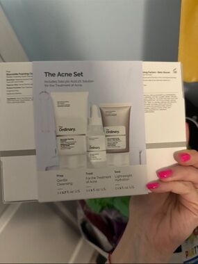 The Ordinary Acne Set with White Packaging and Pink Nails
